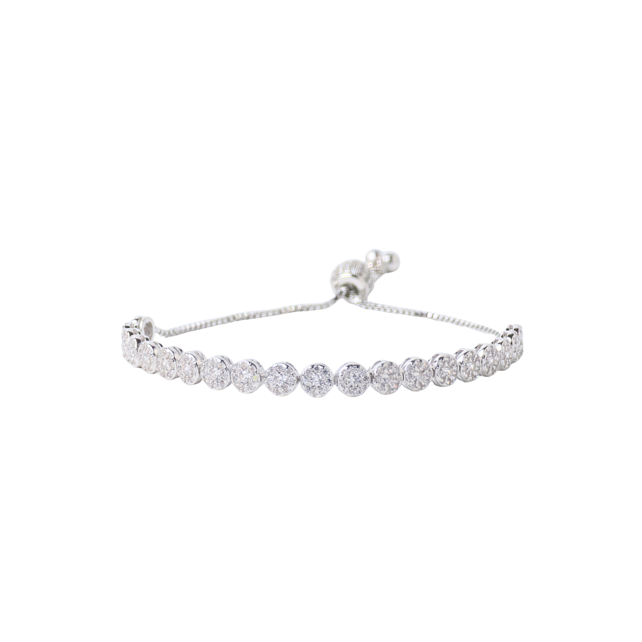 Silver bracelet with clear stones on a white background
